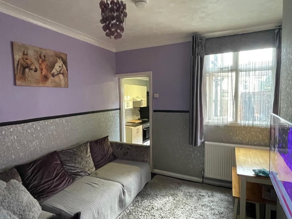 Lot: 1 - PAIR OF FLATS FOR INVESTMENT - view of living room in ground floor flat